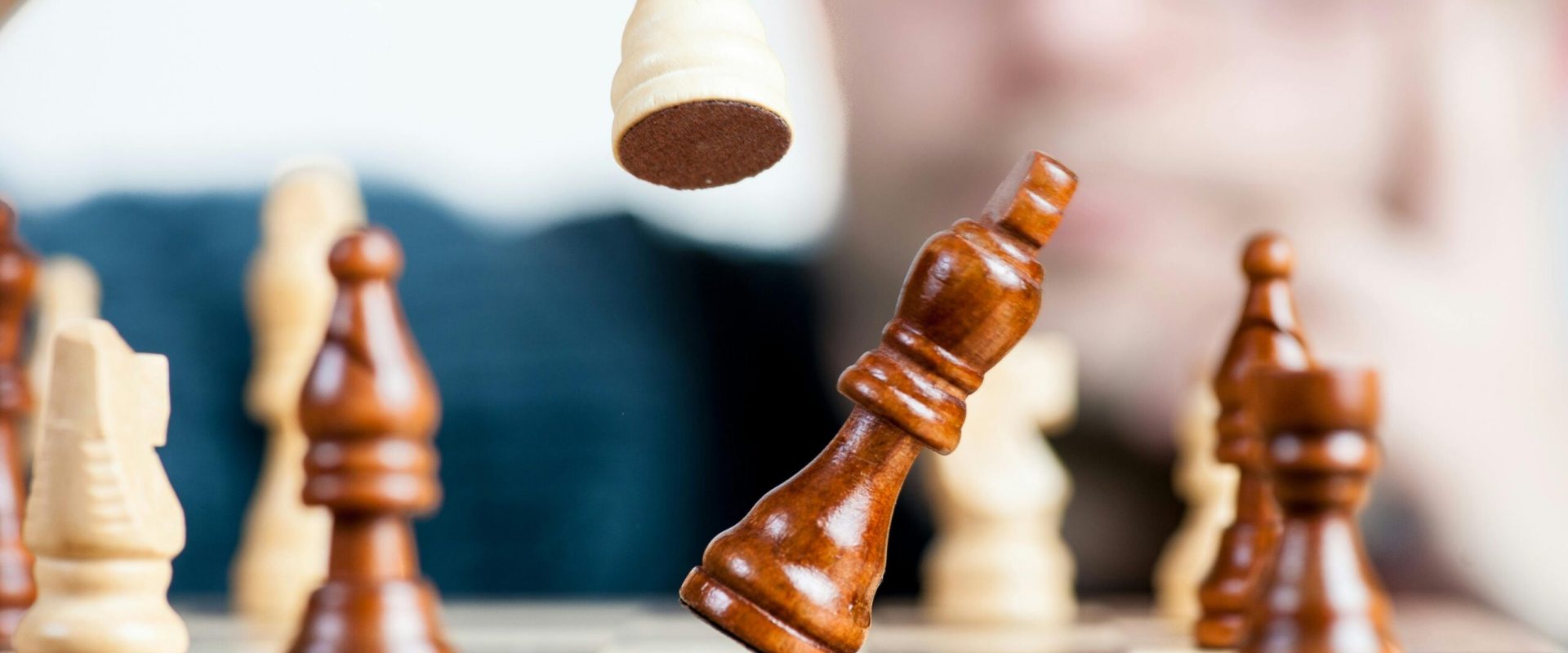 Close-up of a chess game with a focused player, emphasizing strategy and competition.